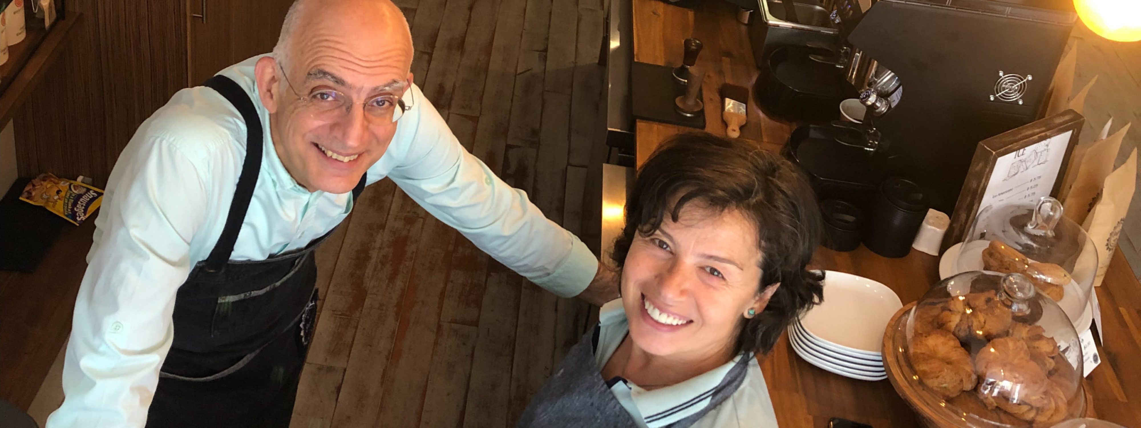 Founders Cüneyt and Mehtap Mertdoğan inside At Origin Coffee, their specialty coffee shop and art gallery on Mount Pleasant Road, Toronto